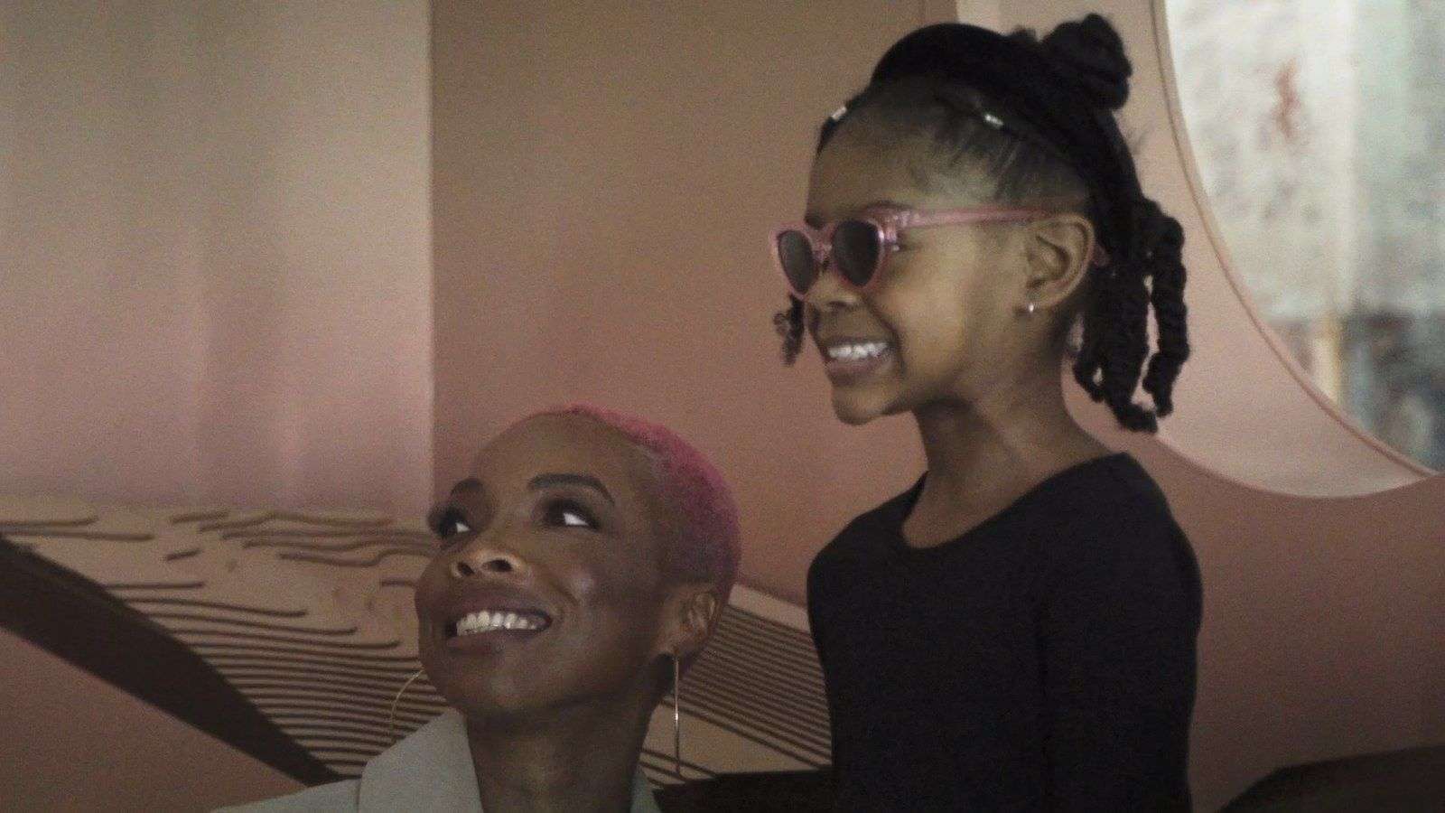 Two visitors inside the Black Women Are Worthy installation